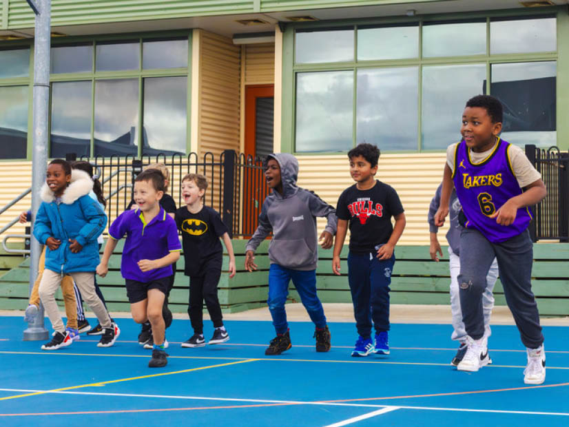 Group of boys running in a line on an court at Wilandra Rise OSHC